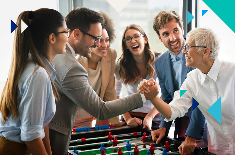 Colleagues spend their lunch break playing table football